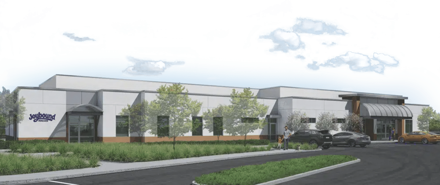 A rendered exterior of a modern building with large windows, trees, and parked cars in front, shown as part of a Pet Adoption campaign.